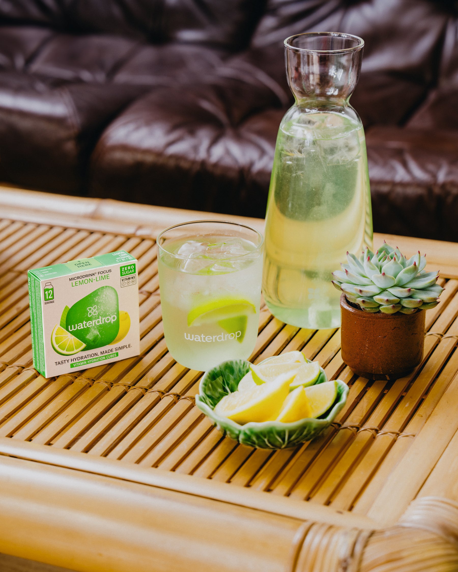 LEMON-LIME Microdrink with glass and citrus on bamboo tray.