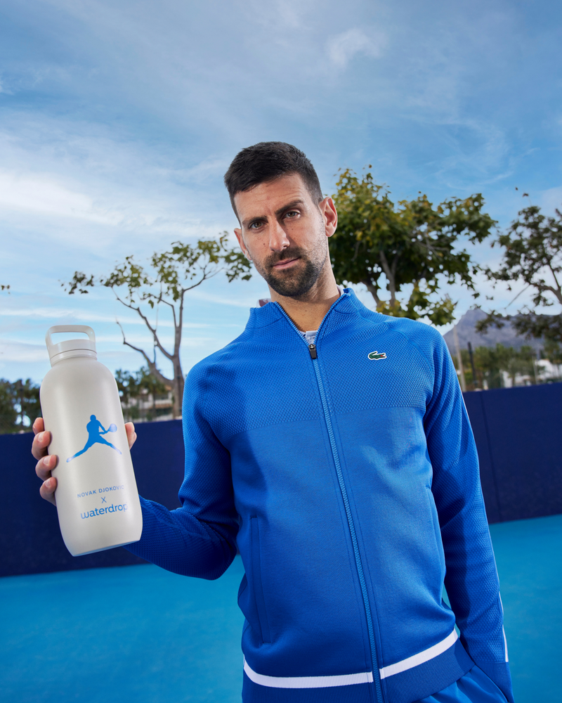 Novak Djokovic holding his All-Purpose Thermo Spout Lid Bottle, showcasing its sleek, practical design.